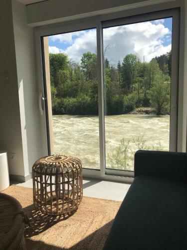 a room with a window with a view of a river at Les 4 gites de la Saisse in Pont-de-Poitte