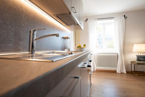 a kitchen counter with a sink and a window at Huberhof Meran in Merano