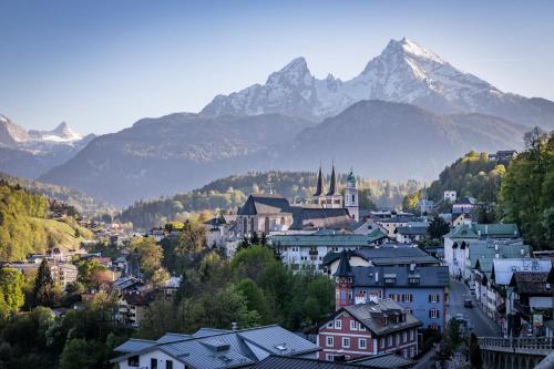 a city with a mountain in the background at Hotel AlpinaRos in Berchtesgaden