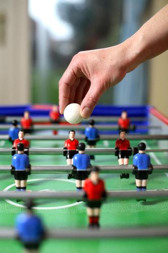 a hand holding a ball in front of a chess board at Campanile Arras - Saint-Nicolas in Saint-Nicolas