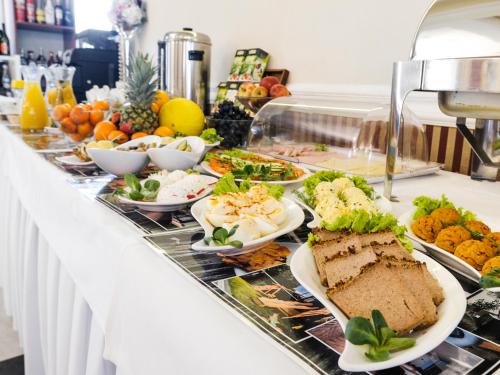 a buffet line with different types of food on it at Hotel Dąbrowski in Oświęcim