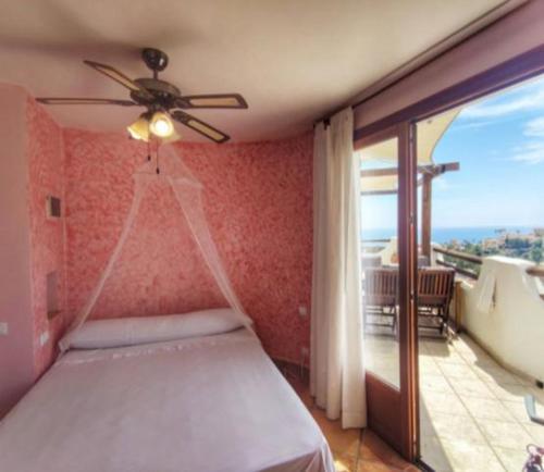a bedroom with a bed and a balcony with a view at APARTAMENTO LUCERO beach campello in Alicante