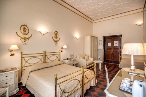 a bedroom with a bed and a chair and a table at Hotel Labelle in Rome