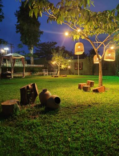 a park at night with a tree and benches at Pousada Vila do Mar in São Luís