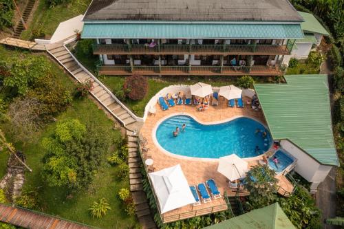an aerial view of a resort with a swimming pool at Tabulia Tree in Manuel Antonio