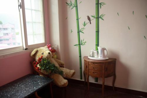 a stuffed teddy bear sitting next to a window at Mozhu B&B in Hualien City