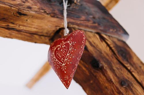 ein Herz-Ornament hängt aus einem Stück Holz in der Unterkunft Erzgebirgshaus in Kurort Altenberg