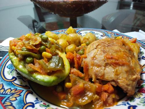 a plate of food with peas and vegetables on a table at Casa Hudié Campestre in Cachipay
