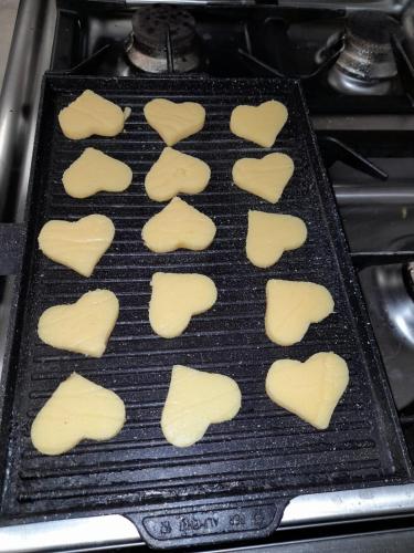 a pan of cookies in the shape of hearts at mammaCristina in Patti