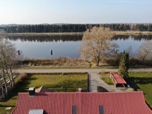 a view of a lake with a red roof at Ferienwohnung mit wunderschönem Blick auf den Nord-Ostsee-Kanal in Breiholz