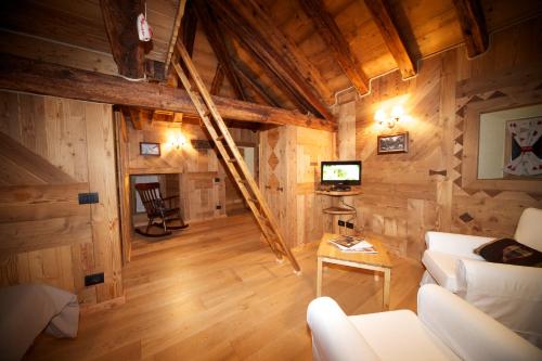 a living room with wooden walls and wooden floors at La Maison Du Seigneur in La Salle