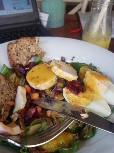 a plate of food with a fork and eggs on it at Kurnik Polski agroturystyka in Tykocin