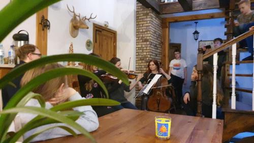 a group of people playing music in a room at Kurnik Polski agroturystyka in Tykocin