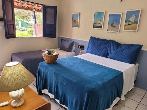 En eller flere senge i et værelse på Pousada Vila do Mar