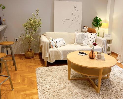 a living room with a couch and a table at Cozy Newly Renovated 1 Bedroom Apartment in the heart of Athens in Athens