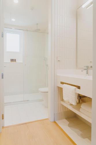 a bathroom with a shower and a sink and a toilet at The Passage Apartments in Donostia-San Sebastián
