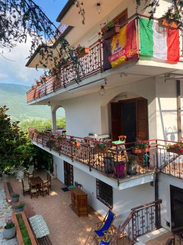 an apartment building with balconies and tables and chairs at B&B Rox e Claudia in Lugnola