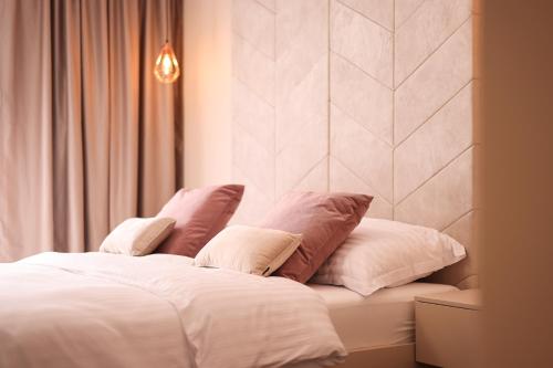 a white bed with four pillows on top of it at D-Palace-Adriatic in Donji Zemunik