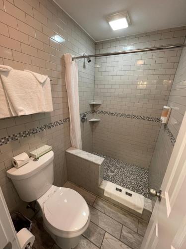 a bathroom with a toilet and a shower at Rio Motel and Suites Wildwood Beach & Boardwalk in Wildwood