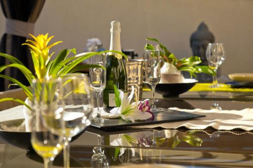 a table with glasses and bottles of wine on it at Villa Victoria Barcelona in Barcelona