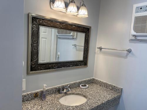 a bathroom with a sink and a mirror at Rio Motel and Suites Wildwood Beach & Boardwalk in Wildwood
