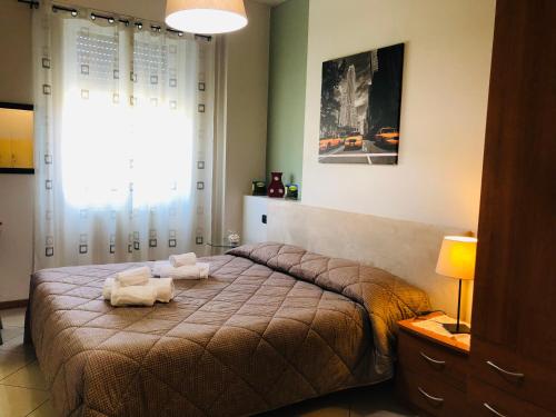 a bedroom with a bed with two towels on it at Residence Oasi Di Monza in Monza