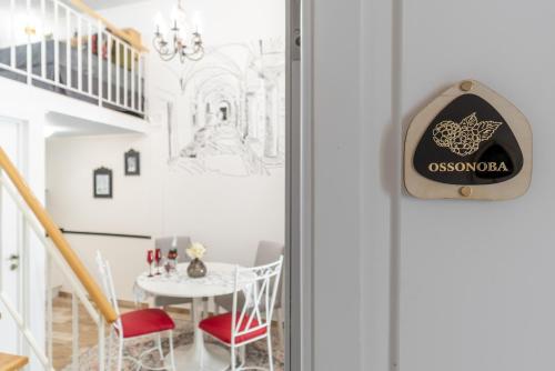 a door with a sign on it next to a table at Main Street Apartments by Raspberry Cascade in Faro