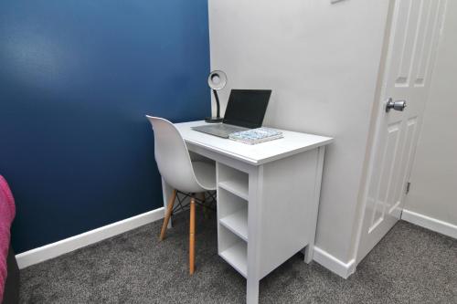 a white desk with a laptop computer on it at Mount Haven's Rest - Free Parking, Netflix & Private Back Garden in Coventry