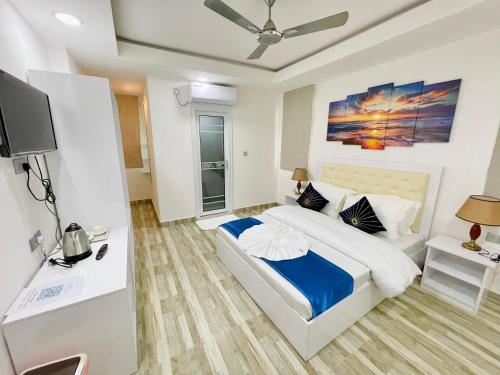 a bedroom with a bed and a tv in it at Marine Holiday in Hulhumale