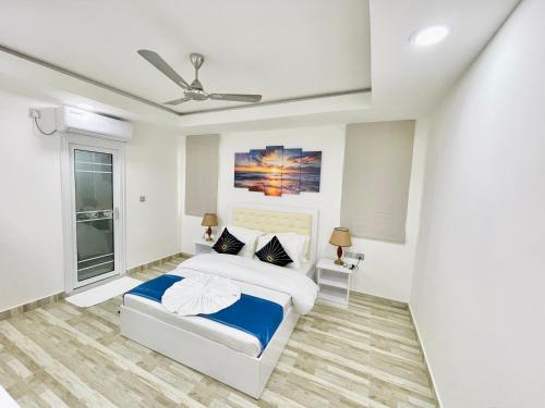 a bedroom with a bed and a ceiling fan at Marine Holiday in Hulhumale