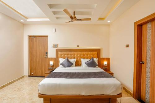 a bedroom with a large bed and a ceiling fan at HOTEL TAIKA in Rāmeswaram