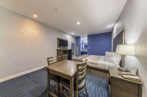 a small hotel room with a bed and a desk and a room at Home Place Inn Spring I-45 North and 1960 in Westfield