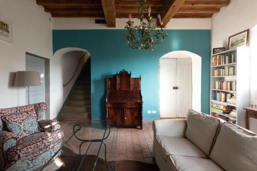 a living room with a couch and a chandelier at Stone House 15th Century in Vicchio