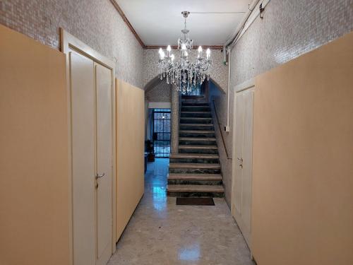 a hallway with a staircase and a chandelier at Residenza Donini in Venice Suite 1 in Venice