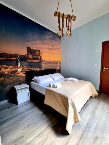 a bedroom with a bed with a painting on the wall at DUOMO 152 NAPOLI in Naples