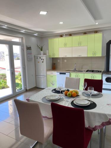 a kitchen with a table with wine glasses on it at Apartments and Rooms Pavla in Senj