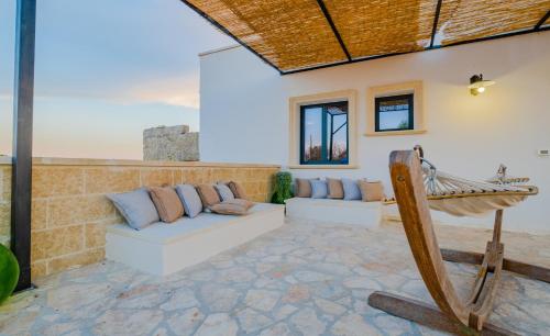 a living room with a couch and a hammock at Villa Li Tratturi Luxury by HDSalento in Corsano