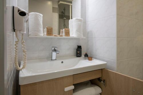 a bathroom with a white sink and a mirror at Bristol Nice in Nice