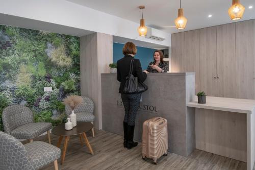 a woman standing at a counter in a salon at Bristol Nice in Nice