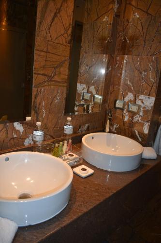 a bathroom with a large sink and a large mirror at Aranwa Cusco Boutique Hotel in Cusco