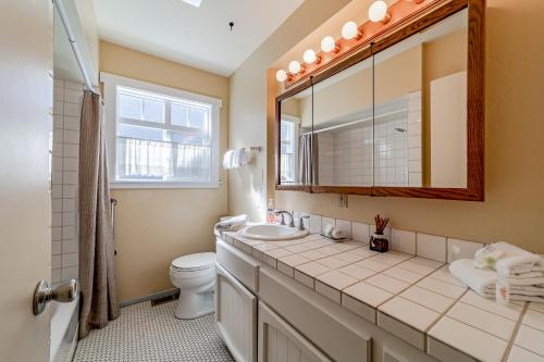 a bathroom with a sink and a toilet and a mirror at Trinidad Village Retreat in Trinidad