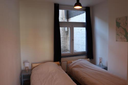 מיטה או מיטות בחדר ב-Le Patenier
