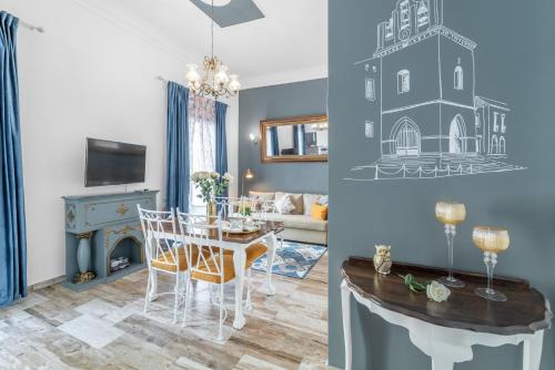 a dining room and living room with a dining table and a room with a fireplace at Main Street Apartments by Raspberry Cascade in Faro