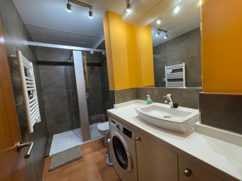 a bathroom with a sink and a washing machine at Palacio Santa Ursula in Toledo
