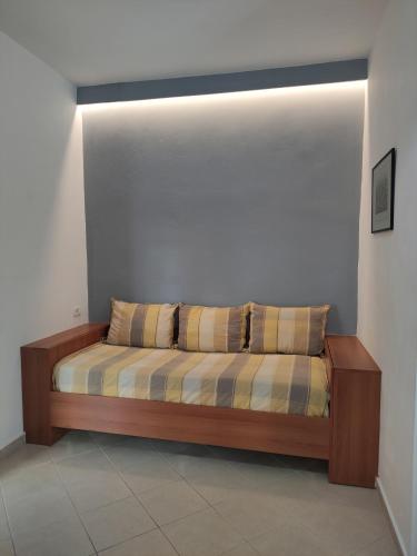 a bed with two pillows on it in a room at Olympia Hotel in Sarandë