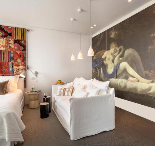 a bedroom with two beds and a painting on the wall at Royal Obidos Scenic Resort in Casal da Lagoa Seca