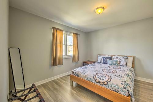 a bedroom with a bed and a mirror and a window at Twin Lakes Escape with Deck Less Than 1 Mi to Beach! in Twin Lakes
