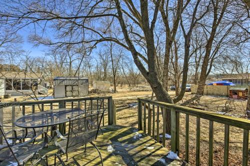 a table and bench on a fence with a tree at Twin Lakes Escape with Deck Less Than 1 Mi to Beach! in Twin Lakes