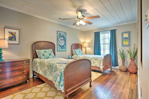 a bedroom with two beds and a ceiling fan at Urbanna Cottage with Private Yard and Water Views in West Irvington