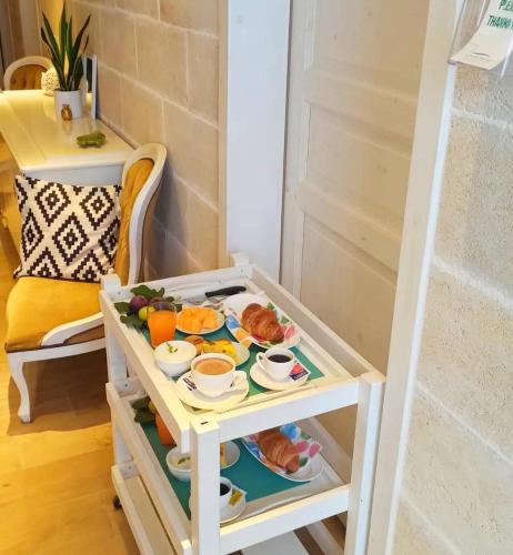 a table with a tray of food on it at B&B Suites Via del Mare in Presicce